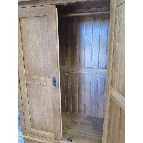 7 - An oak two door wardrobe with a single base drawer, comes in 2 parts, 193cm tall x 109cm x 58cm, gen... 