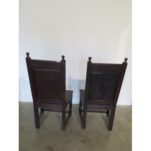 74 - A pair of oak hall chairs with carved backs and frieze, 107cm tall x 52cm wide