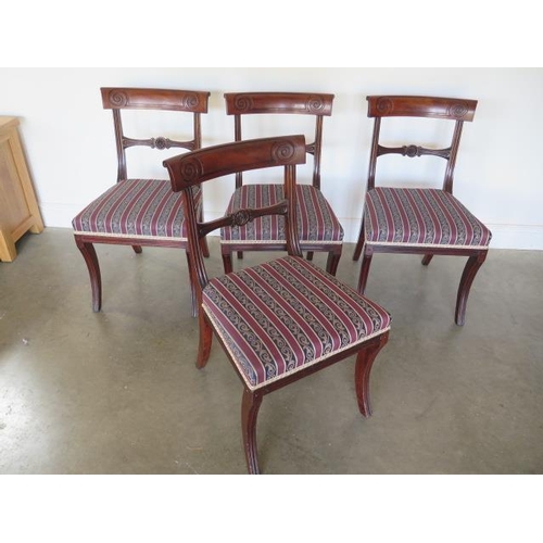 76 - A set of four Regency mahogany bar back dining chairs with upholstered seats and fluted sabre front ... 