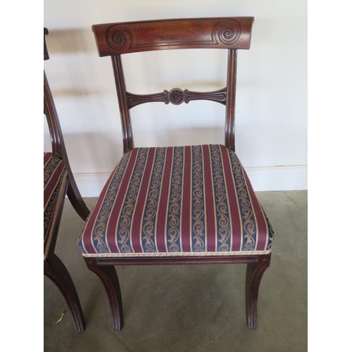 76 - A set of four Regency mahogany bar back dining chairs with upholstered seats and fluted sabre front ... 