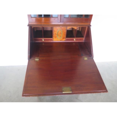 78 - An Edwardian inlaid mahogany two drawer bureau bookcase with a fitted interior standing on square ta... 