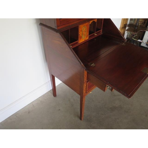 78 - An Edwardian inlaid mahogany two drawer bureau bookcase with a fitted interior standing on square ta... 