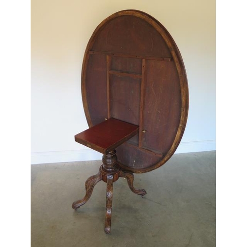 79 - A Victorian walnut tilt top breakfast table on a carved quatrefoil base, 75cm tall x 133cm x 102cm, ... 