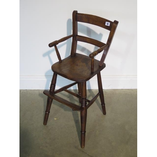 82 - A Victorian child's elm high chair, 80cm tall in good polished condition