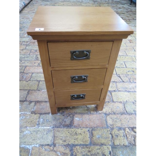9 - An oak three drawer bedside chest, some usage marks