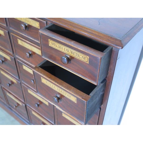 94 - A mahogany chemist apothacary chest with 20 named graduating drawers incorporating 19th century and ... 