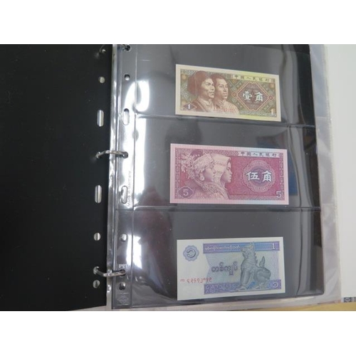 954 - A folder of 70 World banknotes and assorted world coins