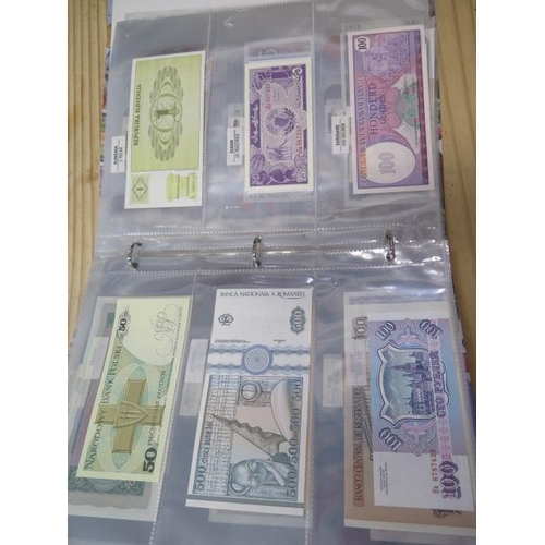 954 - A folder of 70 World banknotes and assorted world coins