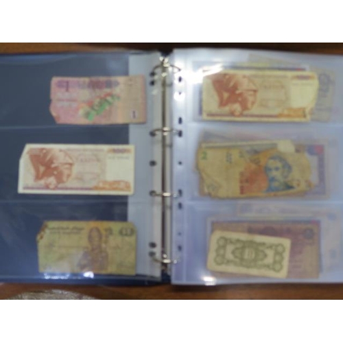 959 - An album containing 138 World bank notes