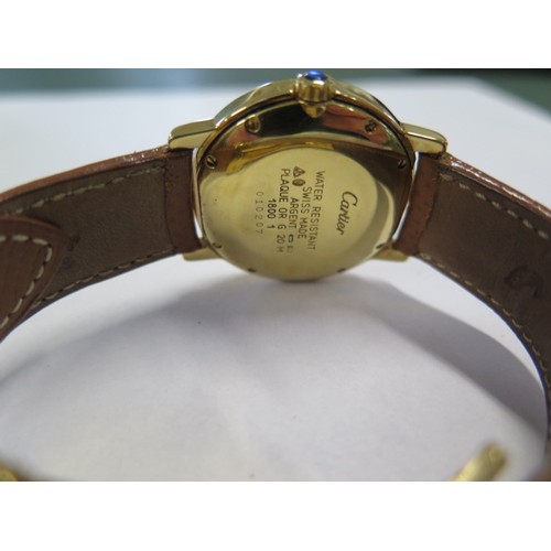 937 - A Cartier gold plated wristwatch 'Must de Cartier' with date aperture and brown leather strap in a l... 