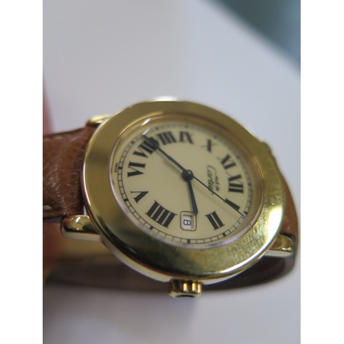 937 - A Cartier gold plated wristwatch 'Must de Cartier' with date aperture and brown leather strap in a l... 