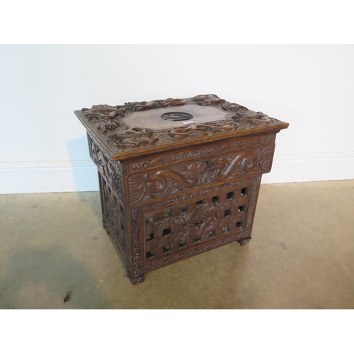 128 - A 19th century Chinese hardwood work box with hinged lid and all over carved dragon detail over a si... 