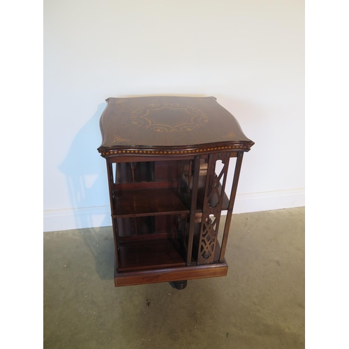131 - A James Shoolbred mahogany and inlaid revolving bookcase with serpentine shaped square top on a revo... 
