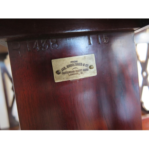 131 - A James Shoolbred mahogany and inlaid revolving bookcase with serpentine shaped square top on a revo... 