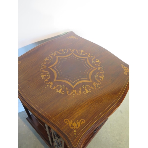 131 - A James Shoolbred mahogany and inlaid revolving bookcase with serpentine shaped square top on a revo... 