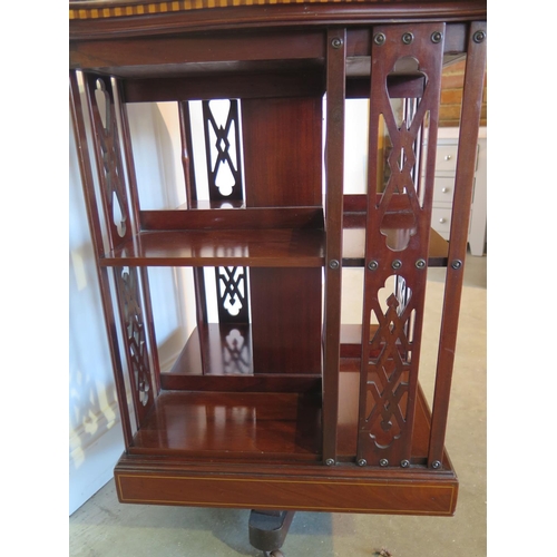 131 - A James Shoolbred mahogany and inlaid revolving bookcase with serpentine shaped square top on a revo... 