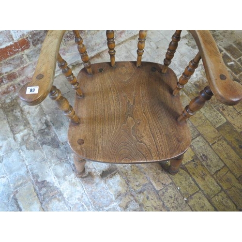 83 - A Victorian ash and elm smokers bow armchair, 79cm tall x 61cm wide, in sturdy condition