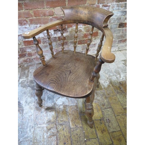 84 - A Victorian ash and elm smokers bow armchair, 85cm tall x 65cm wide, in sturdy condition