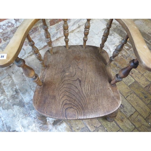 84 - A Victorian ash and elm smokers bow armchair, 85cm tall x 65cm wide, in sturdy condition