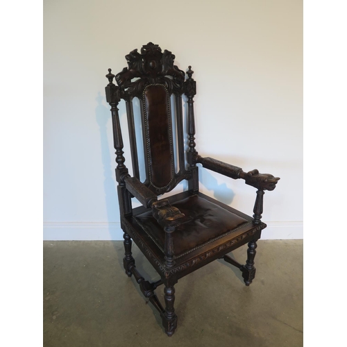 82 - A 19th century oak throne chair, the crested rail with carved lion and unicorn over a brown leather ... 