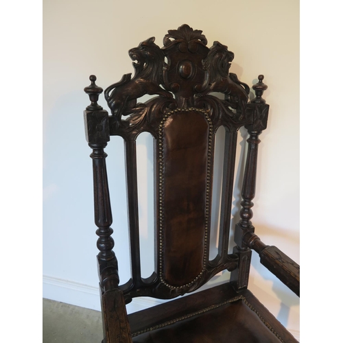 82 - A 19th century oak throne chair, the crested rail with carved lion and unicorn over a brown leather ... 