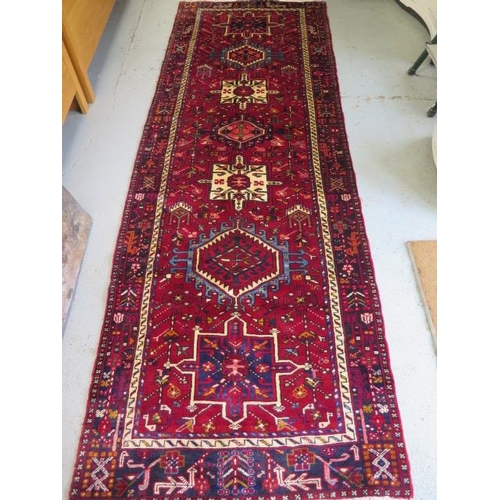 255 - A hand knotted woollen Karajeh rug, 3.05m x 1.15m, in good condition