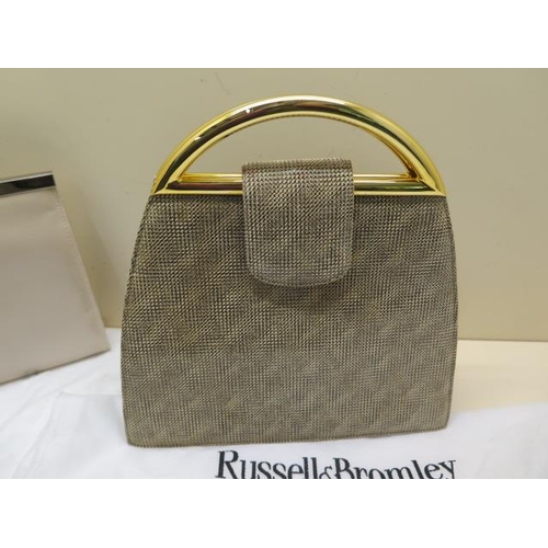 500 - A Peter Kaiser leather clutch bag with strap, 26cm wide, with a Russell and Bromley dust cover, gene... 