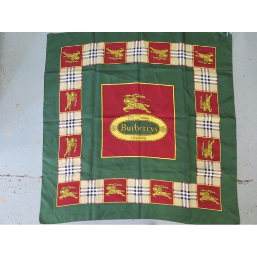 496 - A Burberrys silk scarf, c.1980, detailed with classic check and equestrian knight against a green gr... 