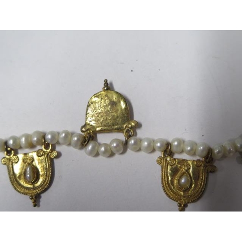 812 - A string of eastern pearls with 5 gilt metal drops, 42cm long