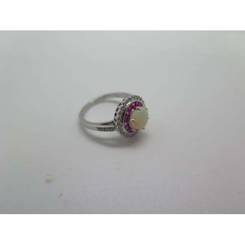 794 - A platinum opal, ruby and diamond ring, hallmarked, size M, head approx 12mm, approx 5 grams, in goo... 