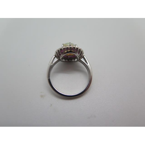 794 - A platinum opal, ruby and diamond ring, hallmarked, size M, head approx 12mm, approx 5 grams, in goo... 