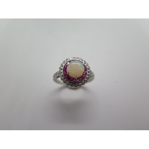 794 - A platinum opal, ruby and diamond ring, hallmarked, size M, head approx 12mm, approx 5 grams, in goo... 