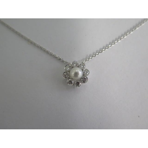 796 - A 18ct white gold diamond and pearl pendant on an 18ct hallmarked gold chain, 40cm long, total diamo... 