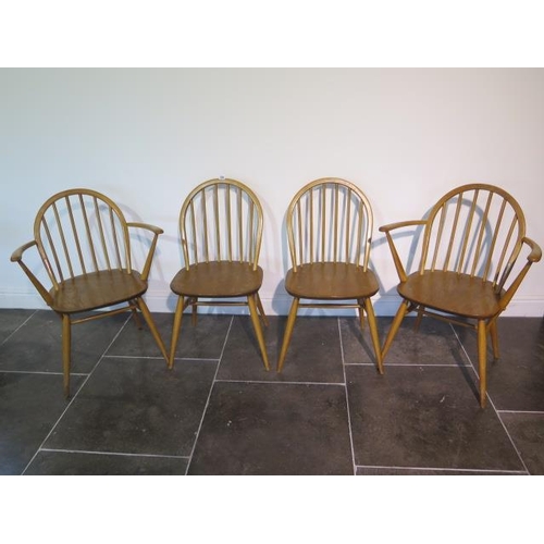 104 - A set of four blonde Ercol Windsor chairs, two being carvers, in clean original condition