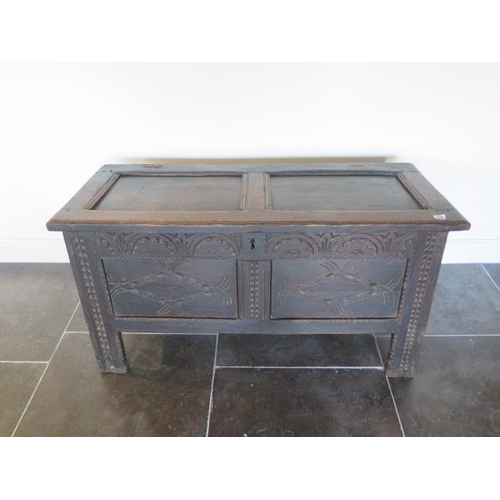 105 - An 18th century oak coffer with a carved front, 62cm tall x 117cm x 50cm, general wear consistent wi... 