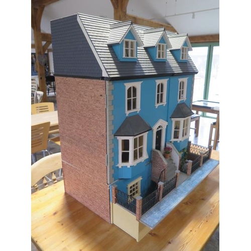 1050 - A large dolls house modelled on an Edwardian four floor house with furniture and accessories and ele... 