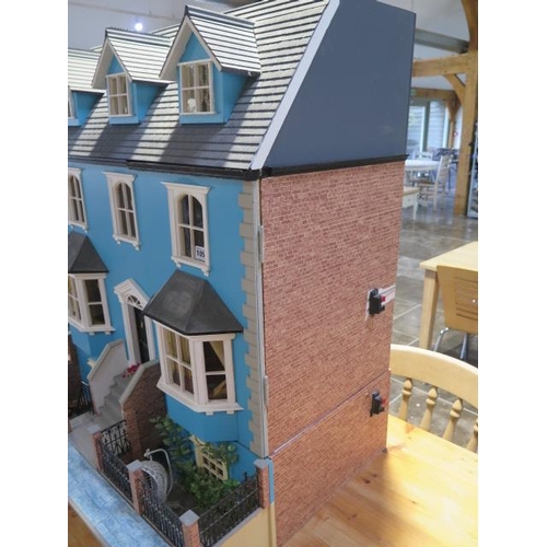 1050 - A large dolls house modelled on an Edwardian four floor house with furniture and accessories and ele... 