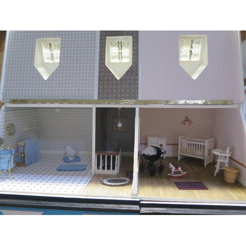 1050 - A large dolls house modelled on an Edwardian four floor house with furniture and accessories and ele... 