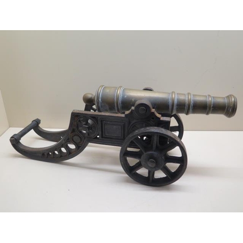 1078 - An ornamental brass cannon on cast iron carriage, 46cm long, some pitting but generally good