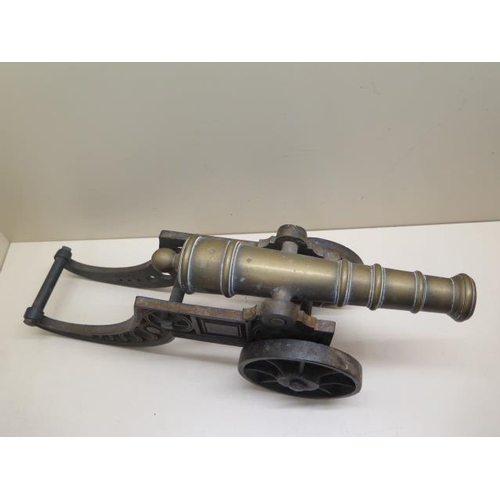 1078 - An ornamental brass cannon on cast iron carriage, 46cm long, some pitting but generally good