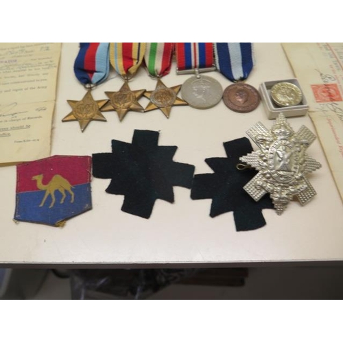 1090 - A group of WWII medals (unnamed) and various documents, badges relating to Pte James Roland Brown 97... 