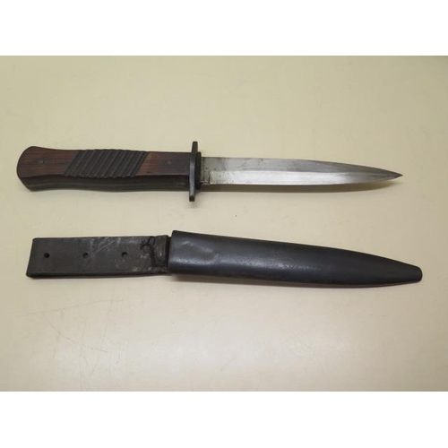 1093 - A WWI German trench knife with scabbard, some denting to scabbard but generally good condition