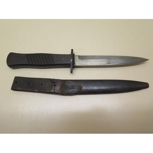 1093 - A WWI German trench knife with scabbard, some denting to scabbard but generally good condition