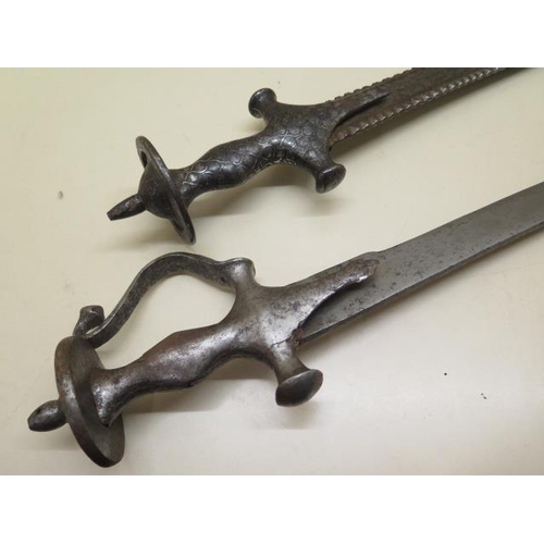 1096 - Two Indian Talwar swords, one with serrated blade, 93cm and 85cm long, both with pitting and some we... 