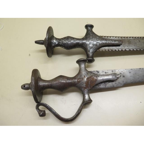 1096 - Two Indian Talwar swords, one with serrated blade, 93cm and 85cm long, both with pitting and some we... 