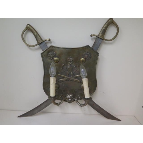 1097 - An Italian artillary shield and sword wall lamp, 54cm x 62cm