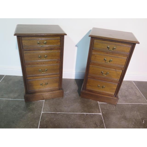 112 - A pair of late Victorian or Edwardian walnut bedside chests each with four graduated drawers with sw... 