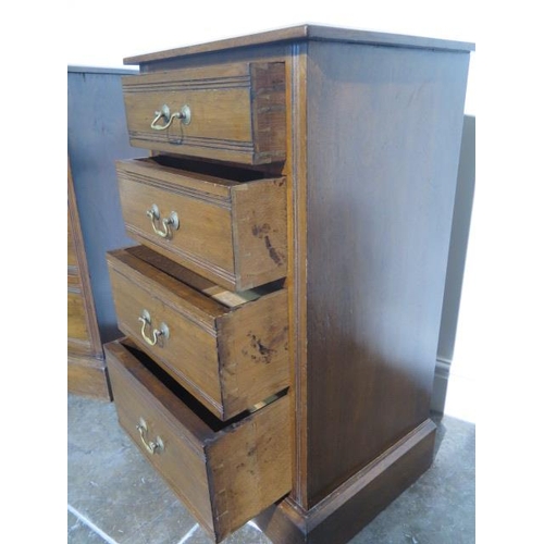 112 - A pair of late Victorian or Edwardian walnut bedside chests each with four graduated drawers with sw... 