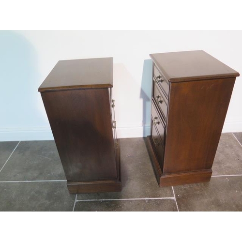 112 - A pair of late Victorian or Edwardian walnut bedside chests each with four graduated drawers with sw... 