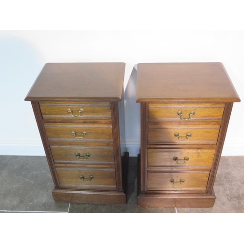 112 - A pair of late Victorian or Edwardian walnut bedside chests each with four graduated drawers with sw... 